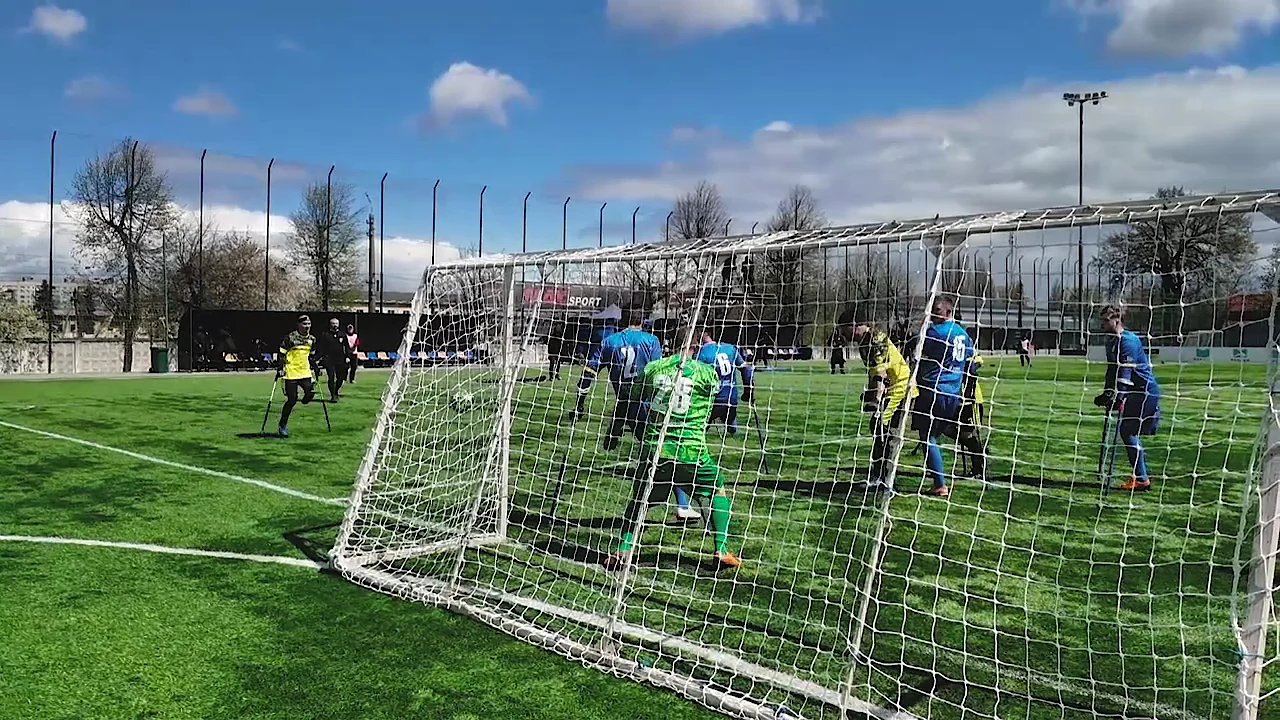 Amputee footballers battling for the ball in front of the goal during a League of the Mighty Ukraine match