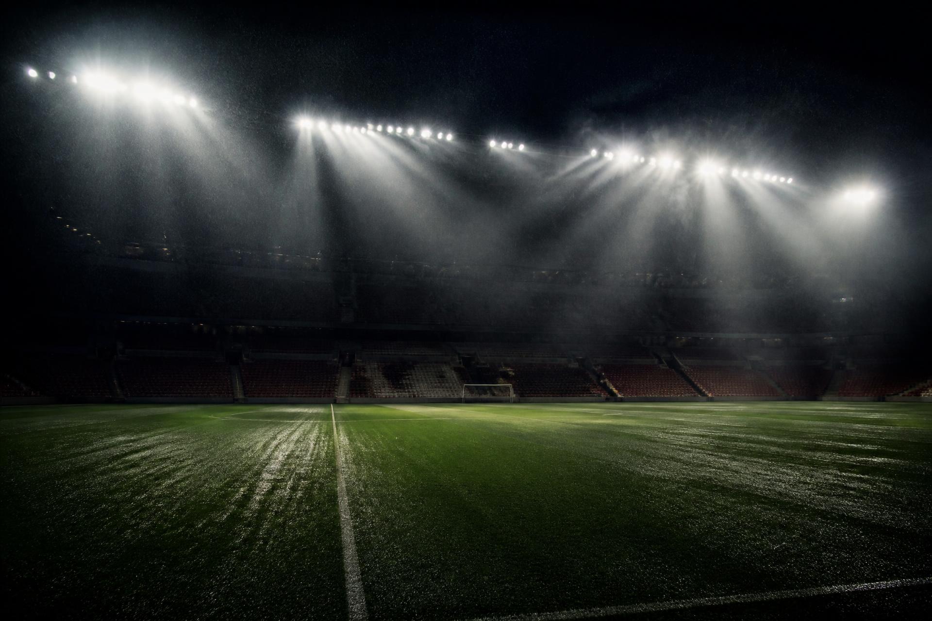 Empty football stadium under floodlights